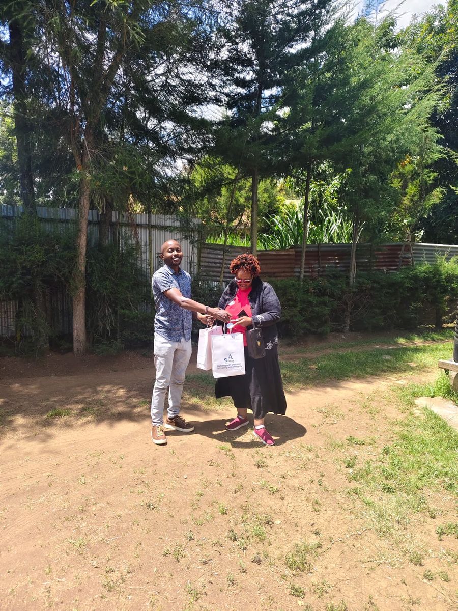 A Silque team member presenting a gift to a client on site