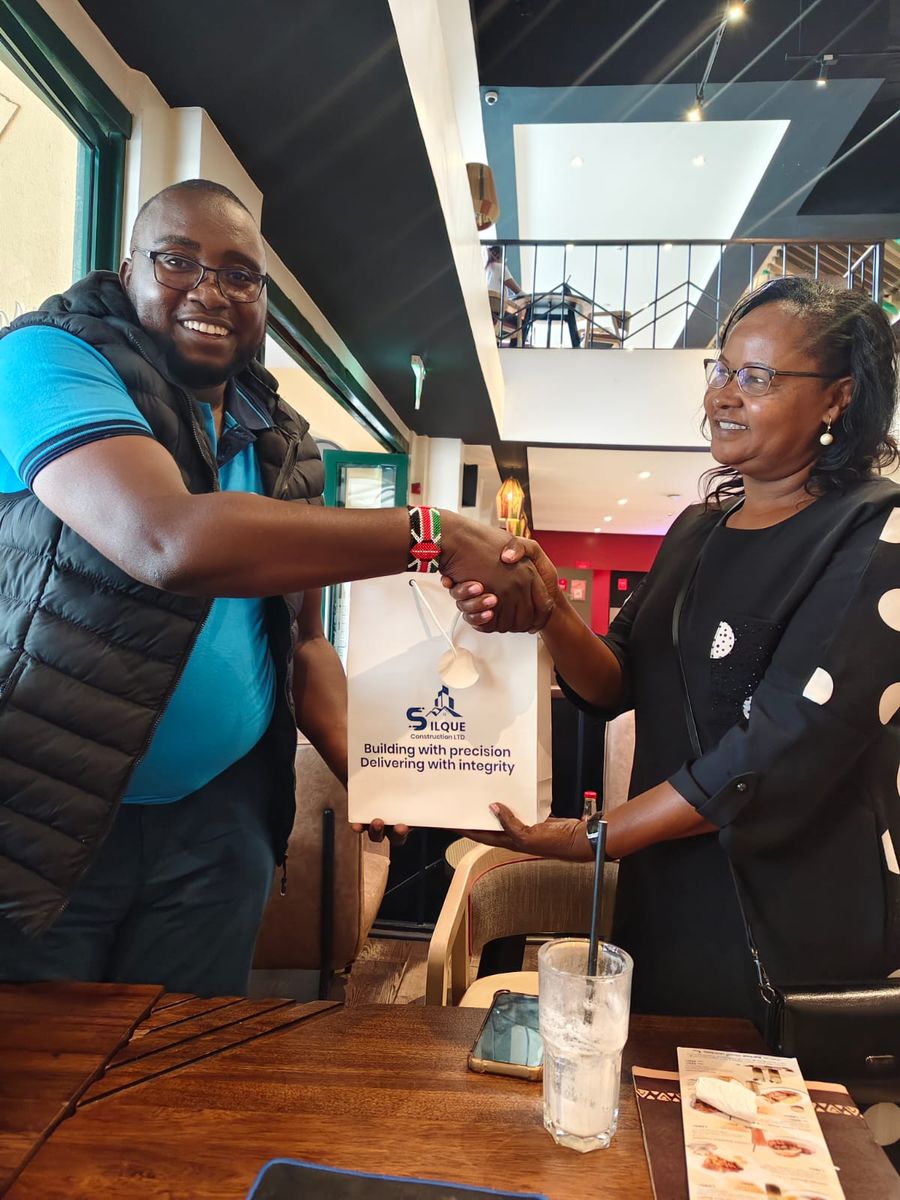 A Silque team member shaking hands with a client