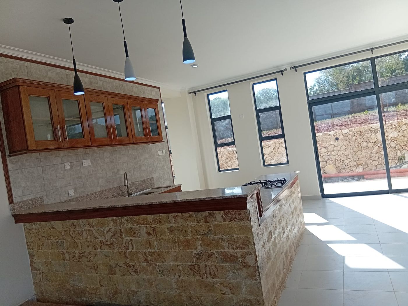 Kilifi interior fit-out - kitchen with stone-clad island