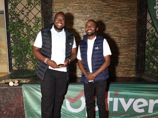 Two members of the Silque team in branded vests